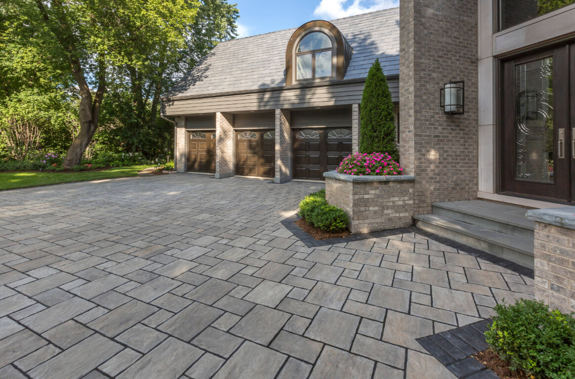 Modern concrete driveway with decorative pavers at Fargo residence