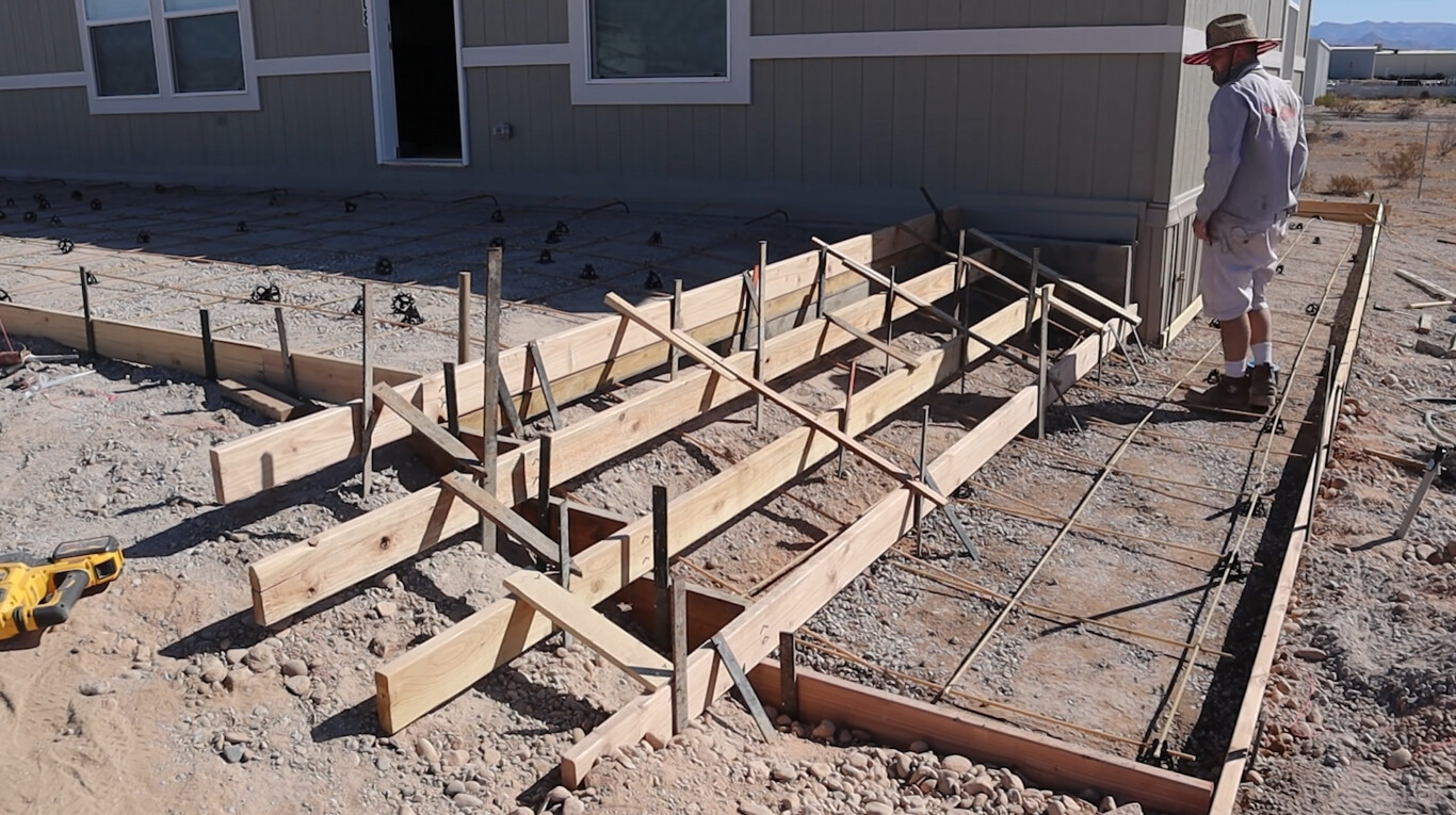 Professional concrete foundation preparation with wooden forms in Fargo, ND