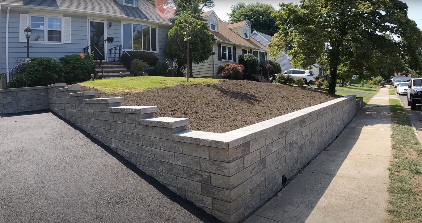 Tiered concrete retaining wall installation at residential property in Fargo